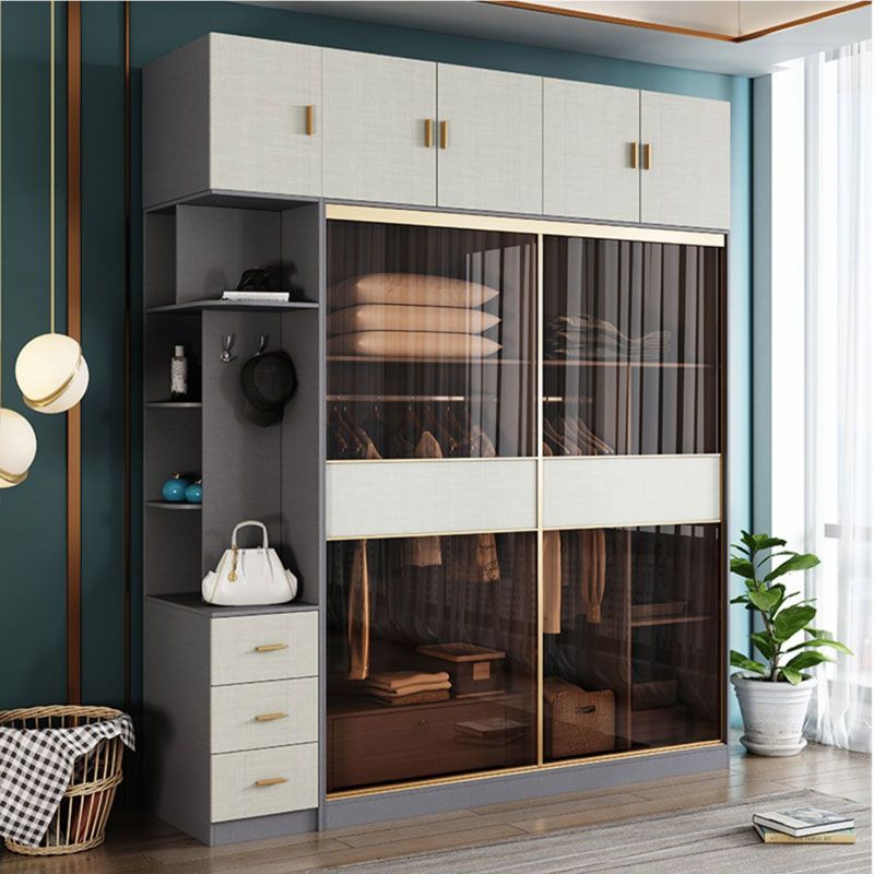 Modern Orren Ellis Linkous Freestanding Grey Wood Wardrobe Closet Featuring Sliding Glass Doors, A Top Cabinet, And An Integrated Side Shelving Unit With Drawers.